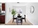 Bright dining area with a glass table, four black chairs, and sliding glass door at 8651 Franklin St, Denver, CO 80229