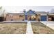 Charming brick home with blue accents, solar panels, and a well-maintained front yard at 8651 Franklin St, Denver, CO 80229