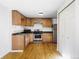 Bright kitchen featuring light wood cabinets, modern stainless steel appliances and wood-look flooring at 8651 Franklin St, Denver, CO 80229