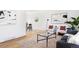 Open-concept living room with hardwood floors, a modern rug, and stylish contemporary decor at 8651 Franklin St, Denver, CO 80229