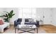 Cozy living area with large windows, a plush sofa, and a bright, inviting atmosphere at 8651 Franklin St, Denver, CO 80229
