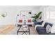 Bright living room featuring a stylish blue sofa, modern decor, and large windows at 8651 Franklin St, Denver, CO 80229