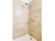Close-up of a shower with beige tiling and a chrome shower head and faucets at 8651 Franklin St, Denver, CO 80229