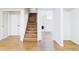Basement staircase featuring wood steps, white risers, leading to the upper level with adjacent laundry area at 8651 Franklin St, Denver, CO 80229