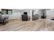 Open concept basement living space featuring versatile area, modern wood flooring, and neutral color palette at 5859 E Ida Pl, Greenwood Village, CO 80111