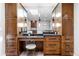 Bathroom featuring custom cabinetry, dual sinks, and bright, contemporary lighting at 5859 E Ida Pl, Greenwood Village, CO 80111