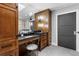 Elegant bathroom with custom wood cabinets, modern fixtures, and a separate shower area at 5859 E Ida Pl, Greenwood Village, CO 80111