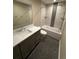 Stylish bathroom boasts modern fixtures, dark pebble flooring, and shower over tub with sleek tiling detail at 5859 E Ida Pl, Greenwood Village, CO 80111