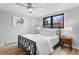 Comfortable bedroom with a modern bed frame, wood floors, and a bright window for natural light at 5859 E Ida Pl, Greenwood Village, CO 80111