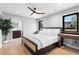 Cozy bedroom with hardwood floors, bright white walls, and view to the ensuite bathroom at 5859 E Ida Pl, Greenwood Village, CO 80111