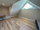 Cozy bedroom with unique triangular window and light wood flooring, perfect for a relaxing retreat at 5859 E Ida Pl, Greenwood Village, CO 80111