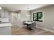 Bright dining area features modern table and chairs, wood floors, and a large window with views of the trees outside at 5859 E Ida Pl, Greenwood Village, CO 80111