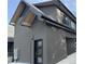 Modern home showcasing clean lines and a contemporary dark exterior with cedar accents at 5859 E Ida Pl, Greenwood Village, CO 80111
