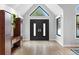 Bright foyer showcasing a hardwood floor, modern door, and vaulted ceiling at 5859 E Ida Pl, Greenwood Village, CO 80111