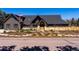 Stunning home exterior with modern design, complemented by mature landscaping and fence at 5859 E Ida Pl, Greenwood Village, CO 80111