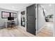Hallway with wood floors leading to a desk area with a view, door, and staircase at 5859 E Ida Pl, Greenwood Village, CO 80111
