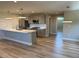 Bright open kitchen featuring stainless steel appliances, modern lighting, and center island with breakfast bar at 5859 E Ida Pl, Greenwood Village, CO 80111