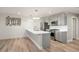 Modern kitchen with gray cabinetry, stainless steel appliances, and a spacious island with sink at 5859 E Ida Pl, Greenwood Village, CO 80111
