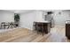 Basement kitchen with eat-in dining area, stainless steel appliances, bar seating, and modern wood floors at 5859 E Ida Pl, Greenwood Village, CO 80111