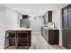 Basement kitchen with stainless steel appliances, breakfast bar, and stylish lighting at 5859 E Ida Pl, Greenwood Village, CO 80111