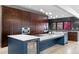 Modern kitchen features custom cabinets, a center island with white countertop, and stainless steel appliances at 5859 E Ida Pl, Greenwood Village, CO 80111