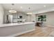 Modern kitchen with an island and dining area, featuring stainless steel appliances at 5859 E Ida Pl, Greenwood Village, CO 80111