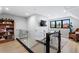Bright landing featuring a glass railing, built-in bookcase, and a view of outside foliage at 5859 E Ida Pl, Greenwood Village, CO 80111