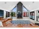 Light-filled living room boasts large windows, a fireplace, an eye-catching feature wall and comfortable seating at 5859 E Ida Pl, Greenwood Village, CO 80111