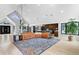 Bright, spacious living room and dining area with large windows, modern decor, and an open floor plan at 5859 E Ida Pl, Greenwood Village, CO 80111