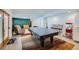Finished basement with game area with pool table, small kitchen, and furniture at 8229 Red Rock Pl, Larkspur, CO 80118