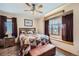 A well-appointed bedroom featuring large windows, a ceiling fan, and warm, inviting decor at 8229 Red Rock Pl, Larkspur, CO 80118