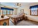 Comfortable bedroom featuring natural light, carpet flooring, and a ceiling fan at 8229 Red Rock Pl, Larkspur, CO 80118