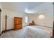 Bright bedroom with neutral carpet, large window and traditional wood wardrobe and rocking chair at 8229 Red Rock Pl, Larkspur, CO 80118