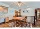 Cozy dining area with wooden table, chairs, and a colorful rug, located near a staircase at 8229 Red Rock Pl, Larkspur, CO 80118