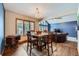 Dining room featuring views into the living room and views of the snowy yard at 8229 Red Rock Pl, Larkspur, CO 80118