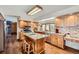 A spacious kitchen with wood cabinets, granite countertops, and hardwood floors at 8229 Red Rock Pl, Larkspur, CO 80118