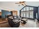 Cozy living room featuring vaulted ceilings, modern windows, and leather seating at 8229 Red Rock Pl, Larkspur, CO 80118