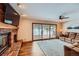 Inviting living room featuring a brick fireplace, sliding glass doors to the deck, and comfortable seating at 8229 Red Rock Pl, Larkspur, CO 80118