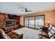 Inviting living room featuring a brick fireplace, sliding glass doors to the deck, and comfortable seating at 8229 Red Rock Pl, Larkspur, CO 80118