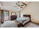 Spacious main bedroom with vaulted ceiling, a ceiling fan, dresser, and deck access at 8229 Red Rock Pl, Larkspur, CO 80118