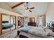 Spacious main bedroom with vaulted ceiling, mirrored closet doors, deck access and neutral colors at 8229 Red Rock Pl, Larkspur, CO 80118