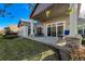 Covered back porch with stone pillars overlooks a beautifully landscaped yard, ideal for relaxing and enjoying nature at 1430 Bluefield Ave, Longmont, CO 80504