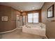 Bathroom with a glass-enclosed shower and a large soaking tub at 1430 Bluefield Ave, Longmont, CO 80504