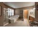 Bright bathroom showcasing a glass-enclosed shower, large soaking tub, and a double sink vanity at 1430 Bluefield Ave, Longmont, CO 80504