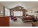 Spacious bedroom with vaulted ceilings, a ceiling fan, a sitting area, and large windows with backyard views at 1430 Bluefield Ave, Longmont, CO 80504