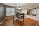 Cozy dining area features hardwood floors, a glass table, and a fireplace at 1430 Bluefield Ave, Longmont, CO 80504
