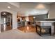 Dining nook with breakfast bar and fireplace offers adjacent access to the kitchen at 1430 Bluefield Ave, Longmont, CO 80504