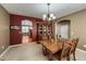 Elegant dining area with an arched doorway, traditional furnishings, and seamless transition to the kitchen at 1430 Bluefield Ave, Longmont, CO 80504
