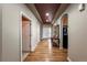 Elegant entryway with hardwood floors, arched doorways, tray ceilings, and stylish decor at 1430 Bluefield Ave, Longmont, CO 80504