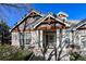 Detailed view of the front entrance with decorative columns, ironwork door, and stone accents at 1430 Bluefield Ave, Longmont, CO 80504